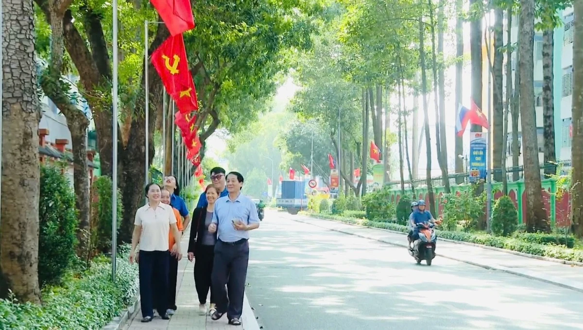 Người dân phường Tam Thắng vui mừng đi dưới những con đường xanh mát, rợp bóng cờ