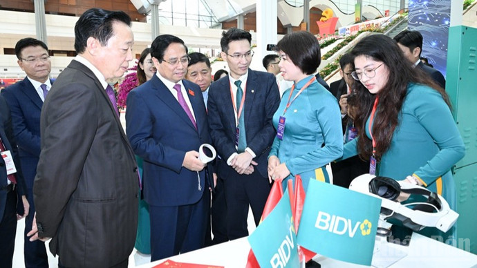 Thủ tướng Phạm Minh Chính tham quan gian trưng bày và trải nghiệm dịch vụ của Ngân hàng BIDV. (Ảnh: Trần Hải)